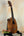 Wooden Kamaka HP-1 Pineapple Soprano Ukulele in solid Hawaiian Koa on black stand