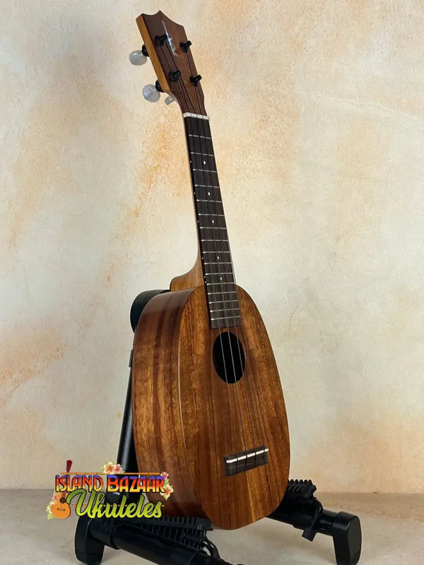 Wooden Kamaka HP-1 Pineapple Soprano Ukulele in solid Hawaiian Koa on black stand