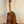 Wooden Kamaka HP-1 Pineapple Soprano Ukulele on black stand with hard case