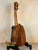 Wooden Kamaka HP-1 Pineapple Soprano Ukulele on black stand with hard case