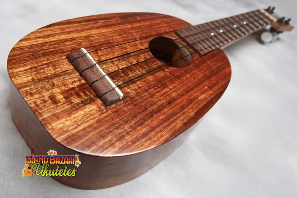 Beautiful Koa wood Kamaka HP-1 Pineapple Tenor Ukulele showcasing rich brown grain patterns