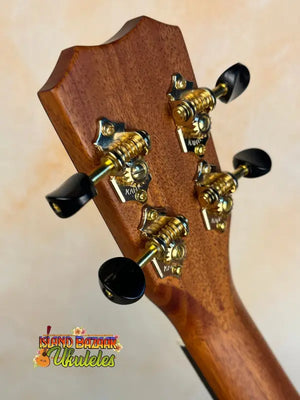 Guitar headstock with gold tuning pegs on Kanile’a Concert Ukulele and Deluxe Gig Bag