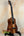 Beautiful Koa wood Kanile’a Concert Ukulele on a black stand with Deluxe Gig Bag
