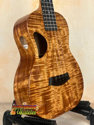 Brown Kanileʻa D-1 tenor ukulele with sound holes in solid Hawaiian koa and deluxe gig bag