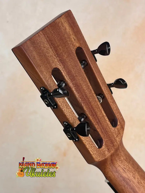 Wooden guitar headstock with black tuning pegs on Kanile’a DK-T D-Hole Tenor Ukulele