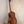 Wooden Kanile’a DK-T D-Hole Tenor Ukulele in Premium Koa on black stand