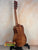 Wooden Kanile’a DK-T D-Hole Tenor Ukulele in Premium Koa on black stand