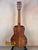 Wooden Kanile’a DK-T D-Hole Tenor Ukulele showcasing premium Koa’s curly grain patterns