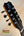 Guitar headstock with chrome tuning pegs and blue logo on Kanile’a Eight String Ukulele