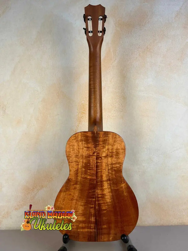 Wooden acoustic guitar showcasing Kanile’a Hawaiian Premium Tenor Ukulele Curly Koa design