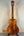 Wooden acoustic guitar showcasing Kanile’a Hawaiian Premium Tenor Ukulele Curly Koa design