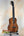Beautiful Curly Koa Kanile’a HNS-T-PREM Concert Ukulele on display with padded gig bag