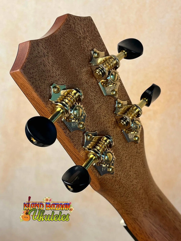 Guitar headstock of Kanile’a HNS-T-PREM Tenor Ukulele with gold tuning pegs and knobs