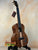 Beautiful Kanile’a HNS-T-PREM Tenor Ukulele made of premium curly koa on a stand