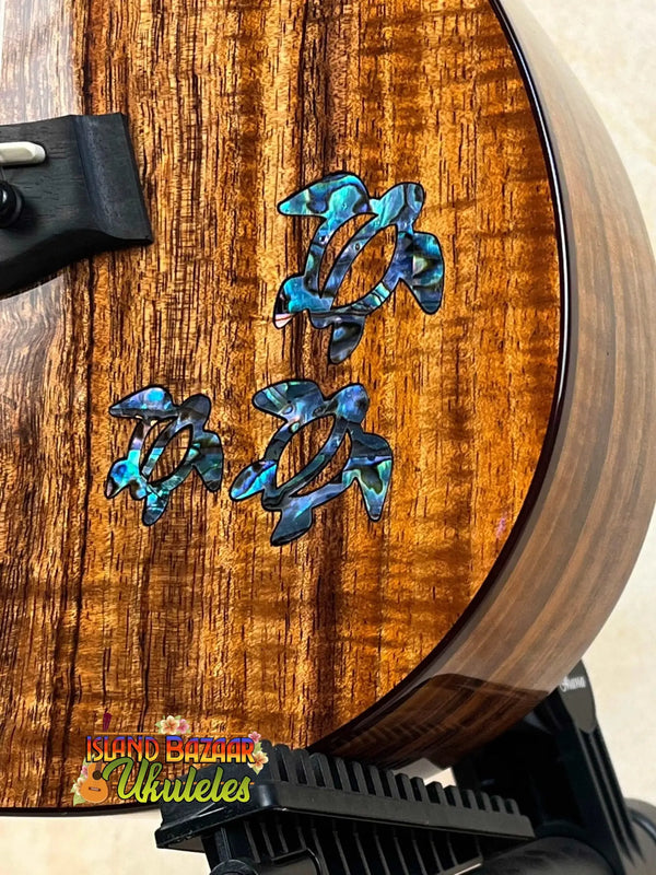 Kanile’a HNS-T-PREM Tenor Ukulele with blue turtle inlays and premium curly koa wood