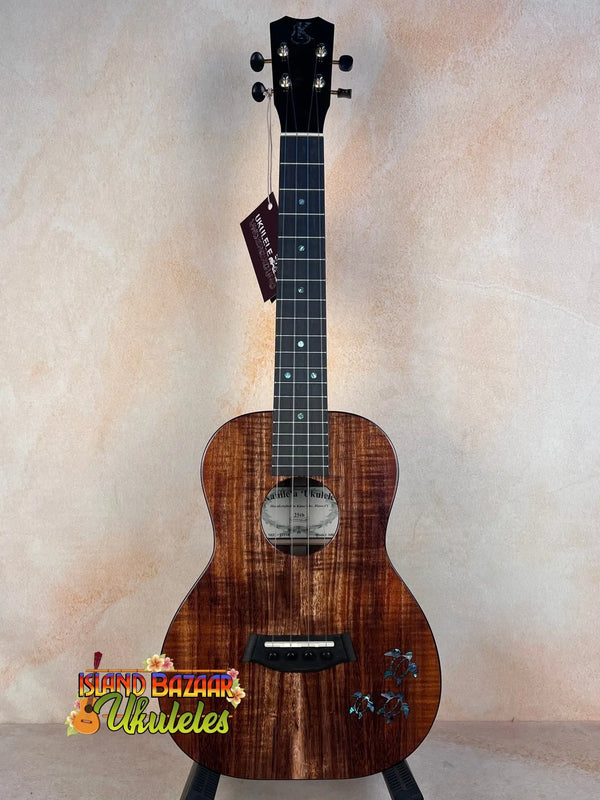 Beautiful Koa wood Kanile’a Honus Tenor Ukulele with decorative inlays and dark grain patterns