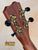 Guitar headstock showcasing gold tuning pegs on Kanile’a Honus Tenor Ukulele design