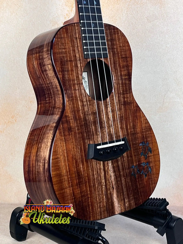 Beautiful Koa wood Kanile’a Honus Tenor Ukulele with dark grain and black hardware