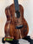 Beautiful Koa wood Kanile’a Honus Tenor Ukulele with dark grain and black hardware