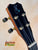 Guitar headstock with black finish and gold tuning pegs for Kanile’a Honus Tenor Ukulele