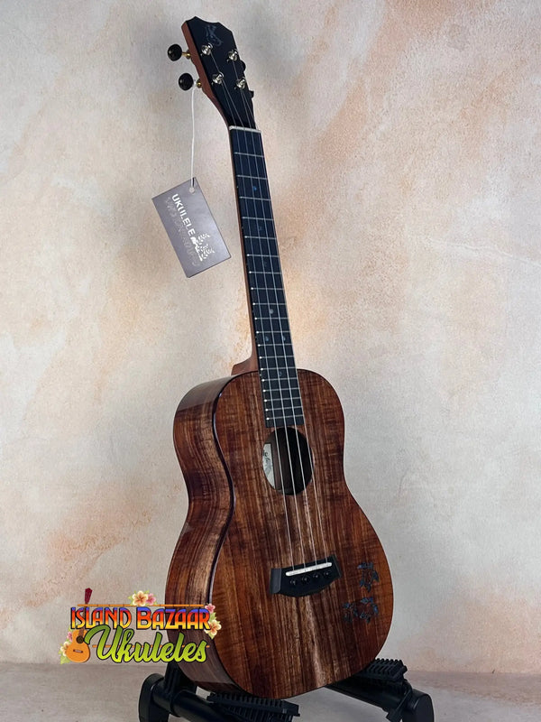 Wooden Kanile’a Honus Tenor Ukulele featuring dark grain and black tuning pegs