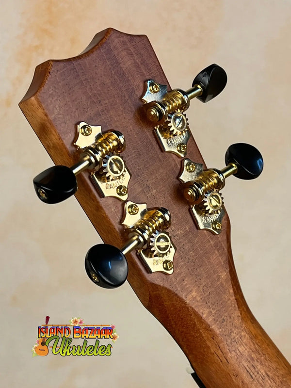 Guitar headstock with gold tuning pegs on Kanileʻa Honus Tenor Ukulele HNS-T