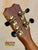 Guitar headstock with gold tuning pegs on Kanileʻa Honus Tenor Ukulele HNS-T