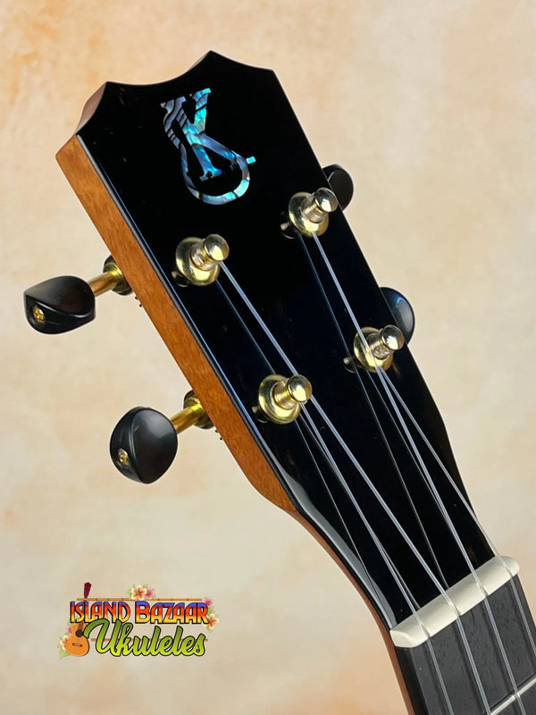 Guitar headstock with black finish and gold tuning pegs for Kanileʻa Honus Tenor Ukulele