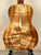 Acoustic guitar featuring golden-brown koa wood, part of Kanileʻa Honus Tenor collection