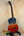 Sunset-colored Kanileʻa ʻILIKAI T Pro Tenor Ukulele on a stand at Island Bazaar