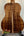 Acoustic guitar showcasing figured Koa wood back of Kanile’a K-1 Deluxe Tenor Ukulele