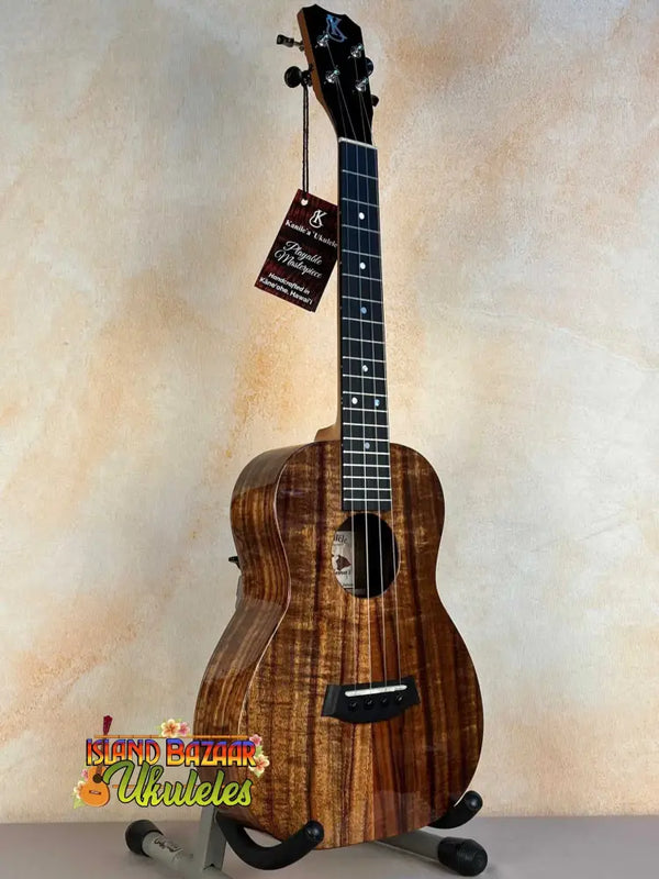 Beautiful Koa wood Kanile’a K-1 Deluxe Tenor Ukulele displayed on a stand