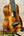 Glossy wooden Kanileʻa K-1 Soprano Ukulele with black tuning pegs and light saddle