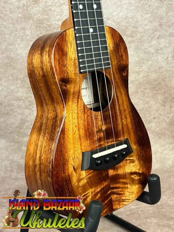 Glossy wooden Kanileʻa K-1 Soprano Ukulele with black tuning pegs and light saddle