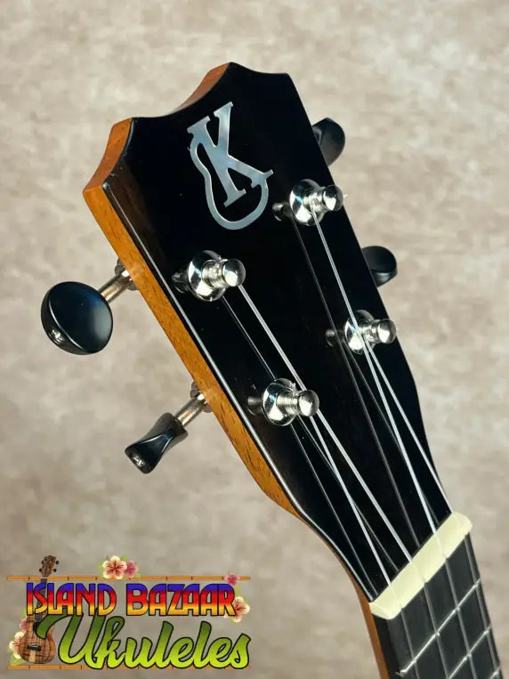 Ukulele headstock with four tuning pegs on Kanileʻa K-1 Soprano featuring tru-r bracing