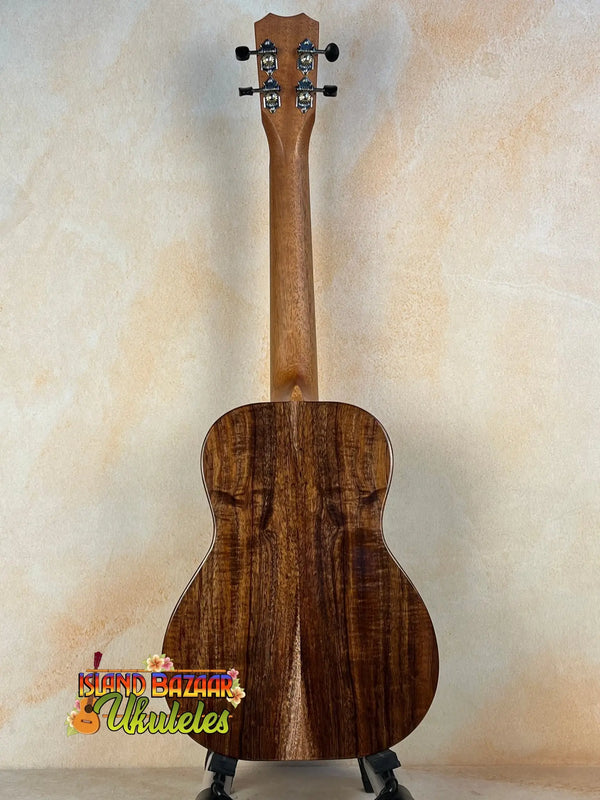 Acoustic guitar crafted from rich brown Koa wood, featured in Kanile’a K-1 Tenor Ukulele