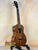 Wooden Kanile’a K-1 Tenor Ukulele in deluxe koa wood on a black stand at Island Bazaar