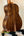 Acoustic guitar with dark walnut wood grain, showcasing Kanile’a K-1 Tenor design