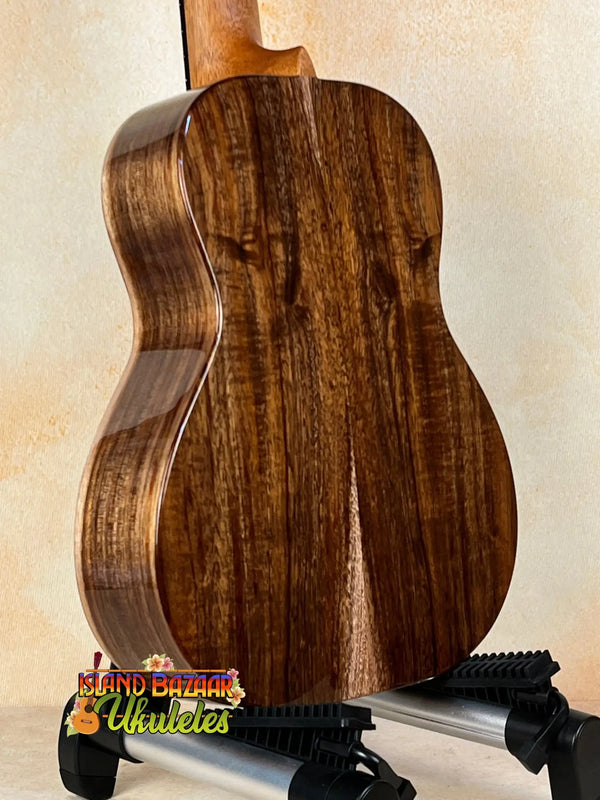 Acoustic guitar with dark walnut wood grain, showcasing Kanile’a K-1 Tenor design