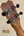 Guitar headstock with black tuning pegs on the Kanile’a K-1 Tenor Ukulele - Deluxe Koa Wood