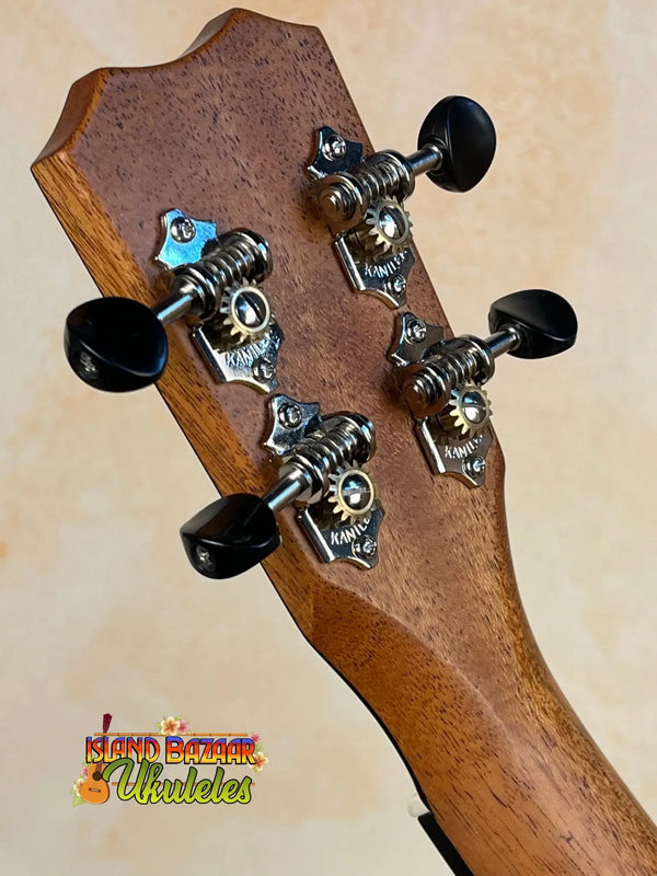 Guitar headstock with black tuning pegs on the Kanile’a K-1 Tenor Ukulele - Deluxe Koa Wood