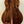 Acoustic guitar with dark wood back on stand showcasing Kanile’a K-1 Tenor Ukulele Deluxe Koa Wood