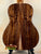 Acoustic guitar with dark wood back on stand showcasing Kanile’a K-1 Tenor Ukulele Deluxe Koa Wood