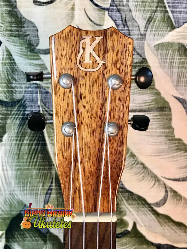 Wooden ukulele headstock with K logo and tuning pegs on Kanile’a K-1 Tenor at Island Bazaar