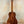 Wooden Kanile’a K-2 Deluxe Concert Ukulele with Hawaiian Koa Body on black stand