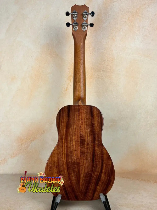 Wooden Kanile’a K-2 Deluxe Concert Ukulele with Hawaiian Koa Body on black stand