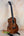 Beautiful Koa wood Kanilea K-2 Premium Tenor Ukulele with dark grain in display stand