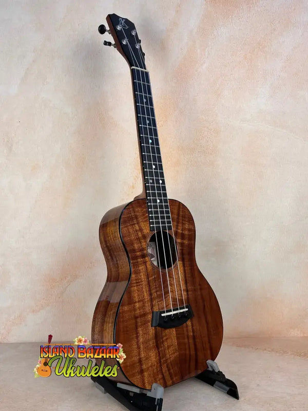 Beautiful Koa wood Kanilea K-2 Premium Tenor Ukulele with dark grain in display stand