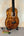Beautiful Kanile’a K-3 Baritone Ukulele with Curly Koa Body and Maple Rosette on stand