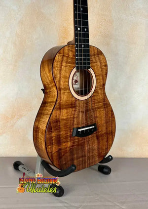 Beautiful Kanile’a K-3 Baritone Ukulele with Curly Koa Body and Maple Rosette on stand